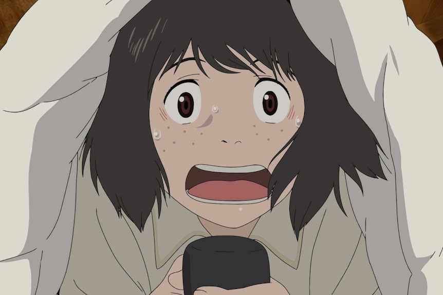 A still from an animated movie showing a nervous-looking Japanese girl holding a microphone, lying in bed under a blanket