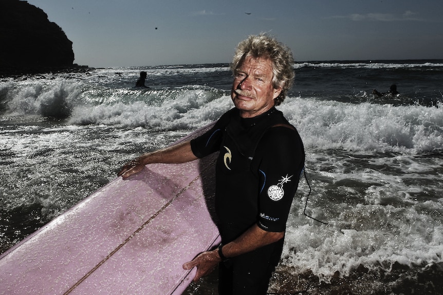 Midget Farrelly pictured with a surfboard at Sydney's Avalon Beach