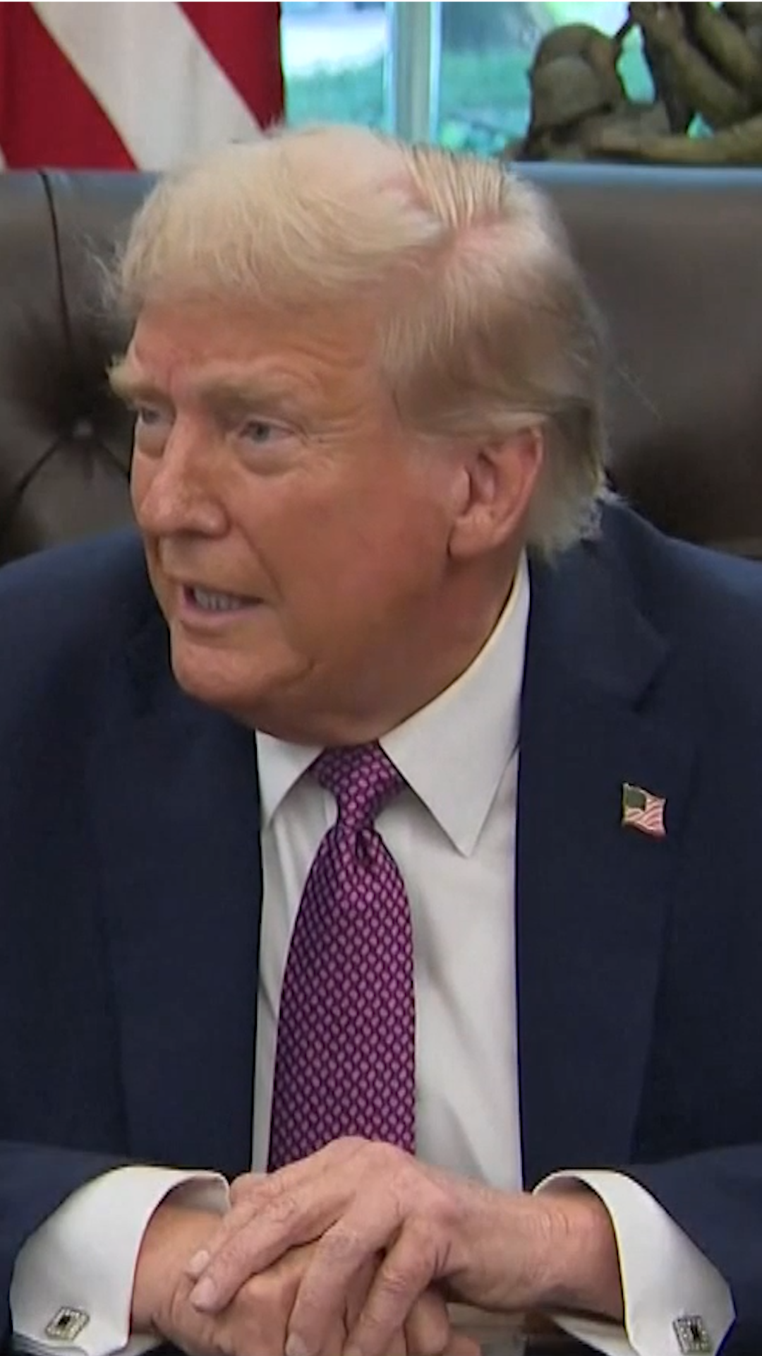 Donald Trump sits at his desk at the Oval Office 