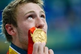 Matthew Mitcham kisses his gold medal he won in the men's 10m platform diving final
