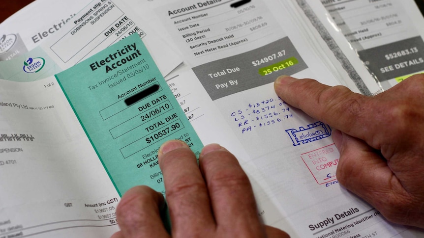 A man looks at energy bills.