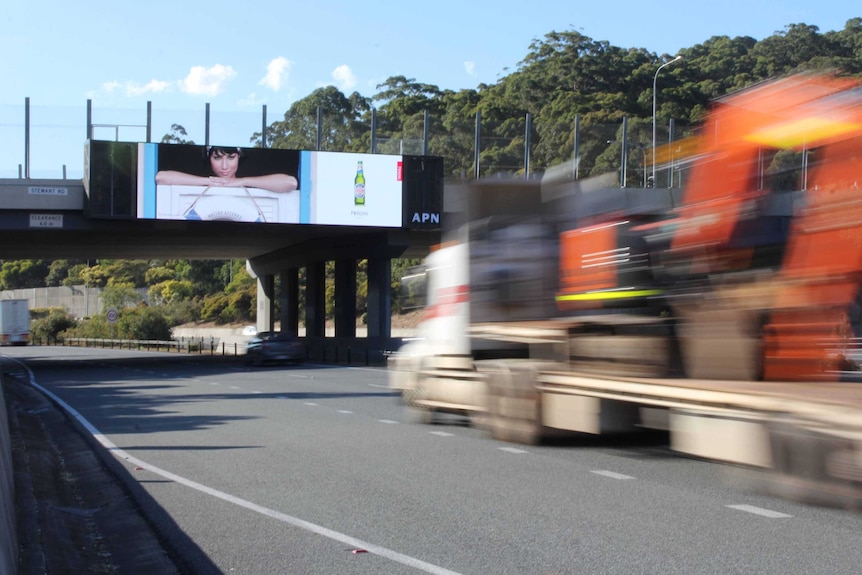 Un camión pasa por debajo de un gran cartel electrónico en la M1 en Tugun.