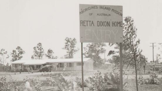 A historical photograph of the Retta Dixon Home in black and white.