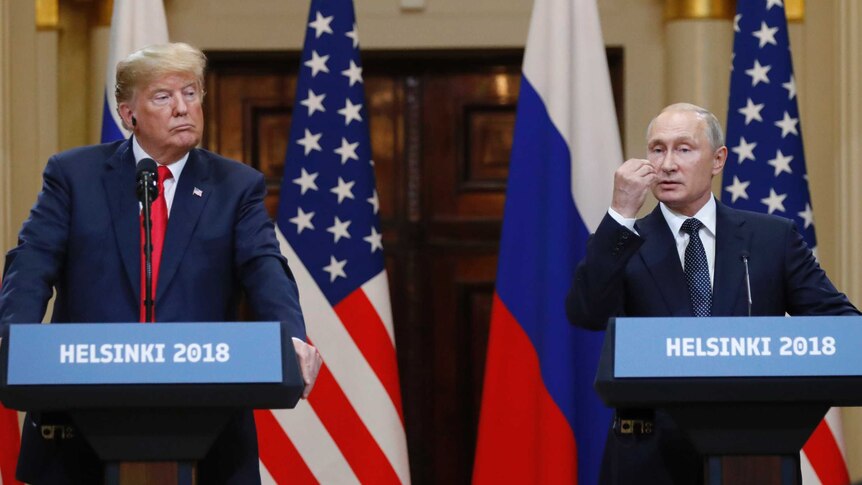 U.S. President Donald Trump listens to Russian President Vladimir Putin during a press conference