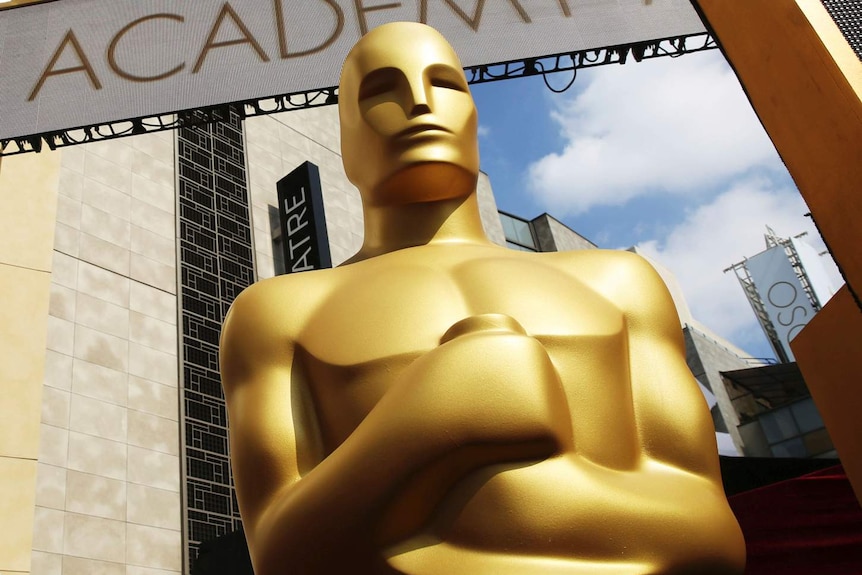 An Oscar statue appears outside the Dolby Theatre for the 87th Academy Awards in Los Angeles