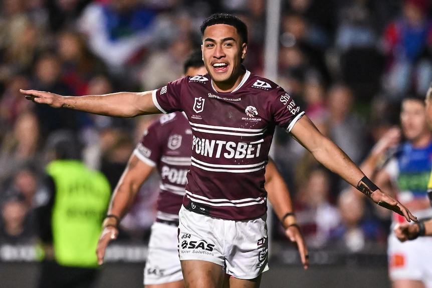 Lehi Hopoate of the Sea Eagles celebrates scoring a try, with his arms outstretched like a plane