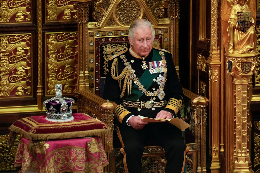 King Charles sits on golden throne next to Queen Elizabeth's crown