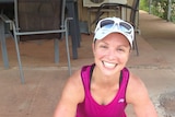 A woman smiling in running gear