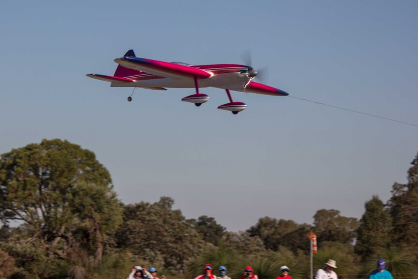 An aircraft takes off in the aerobatic ring.