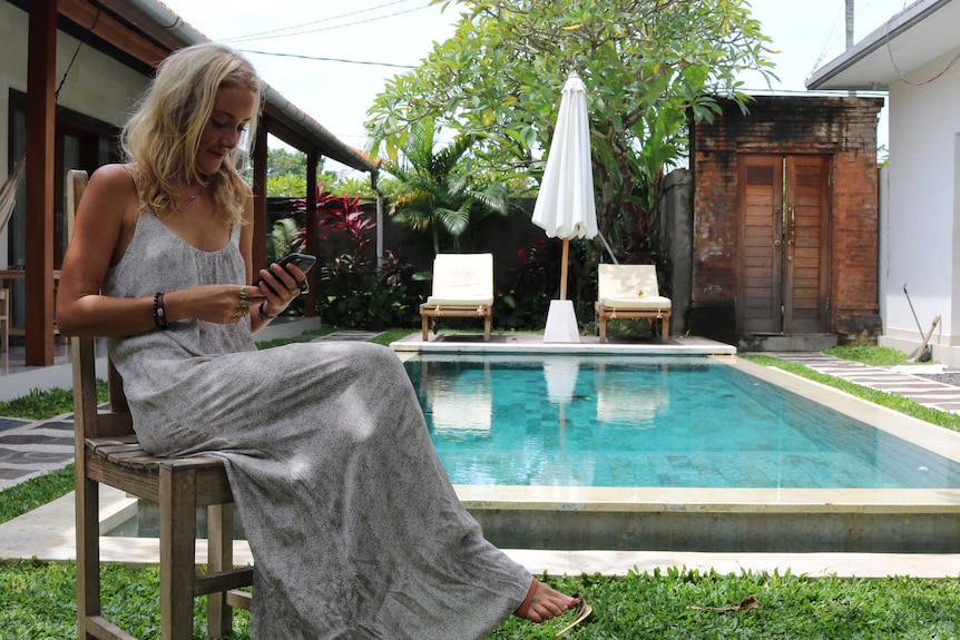 Sarah Newland works next to the pool in Canggu