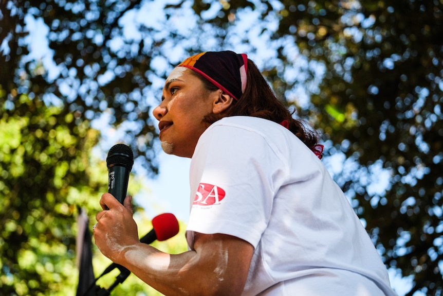 A woman speaking into a microphone