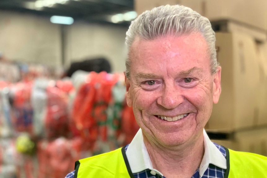 Peter Tamblyn from Close the Loop inside their Somerton factory, standing in front of bales of soft plastics.