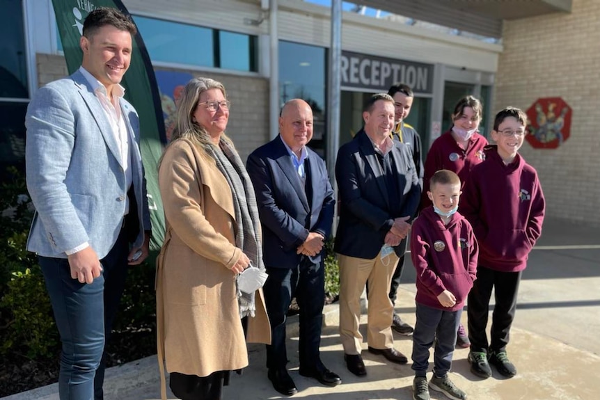 A group of people and students smile for a photo, Ausnew Home Care, NDIS registered provider, My Aged Care