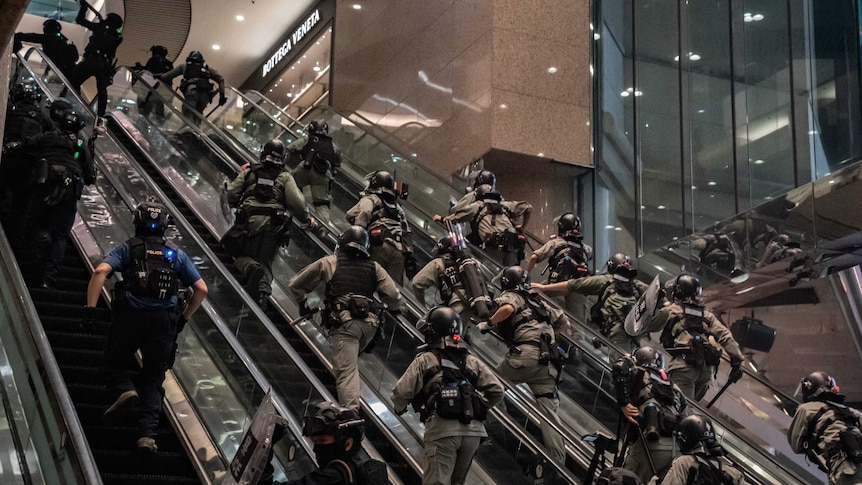 Hong Kong riot police charge protesters at a shopping mall during an anti-national security law demonstration, July 1, 2020