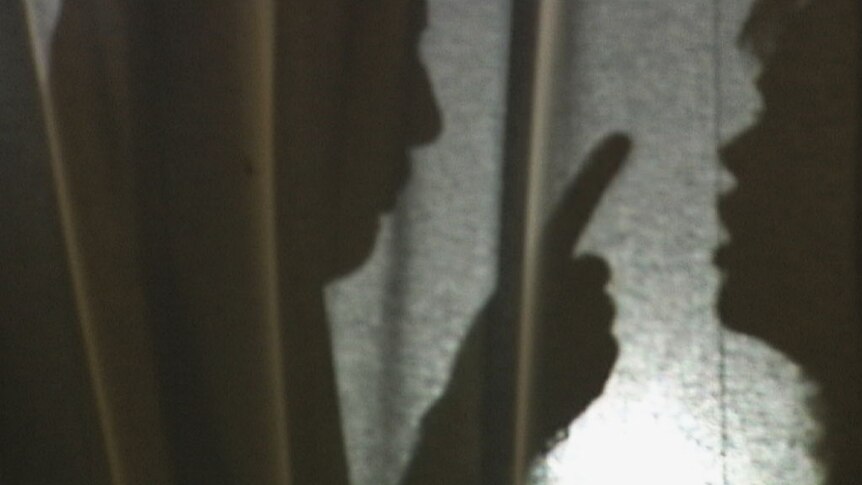 Silhouette of unidentifiable man and woman arguing.