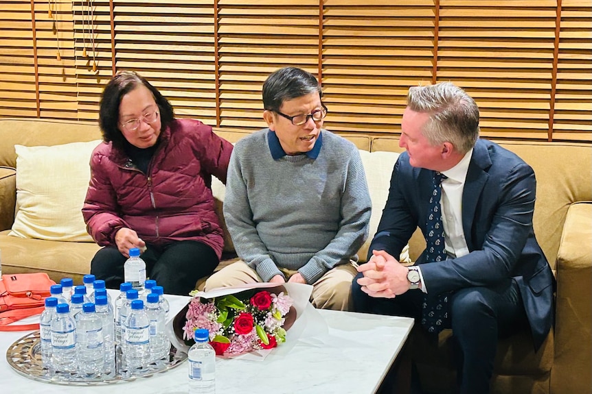 Chau Van Kham, centre, pictured with his wife Trang and Chris Bowen.