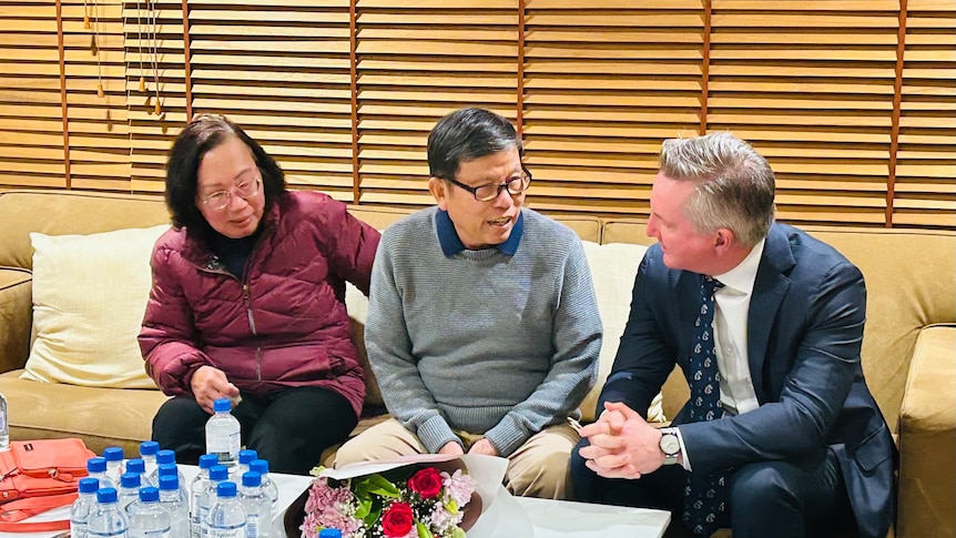 Chau Van Kham, centre, pictured with his wife Trang and Chris Bowen.