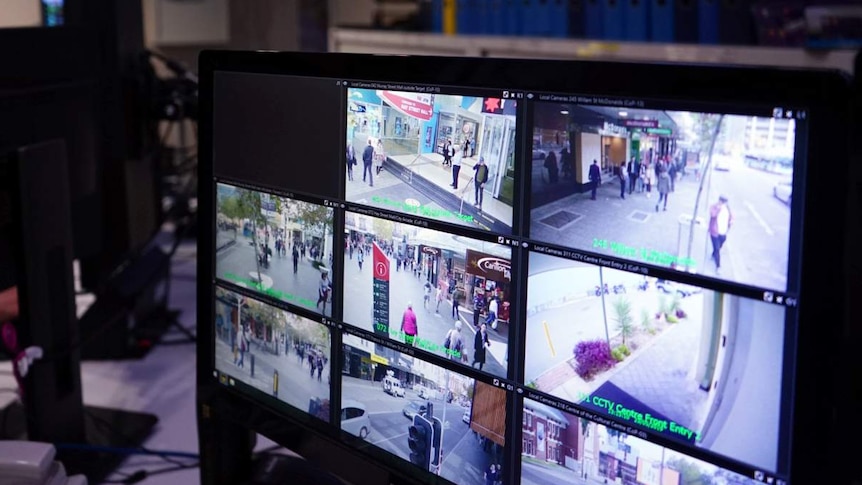An auxiliary police officer monitors CCTV cameras at the CityWatch surveillance centre.