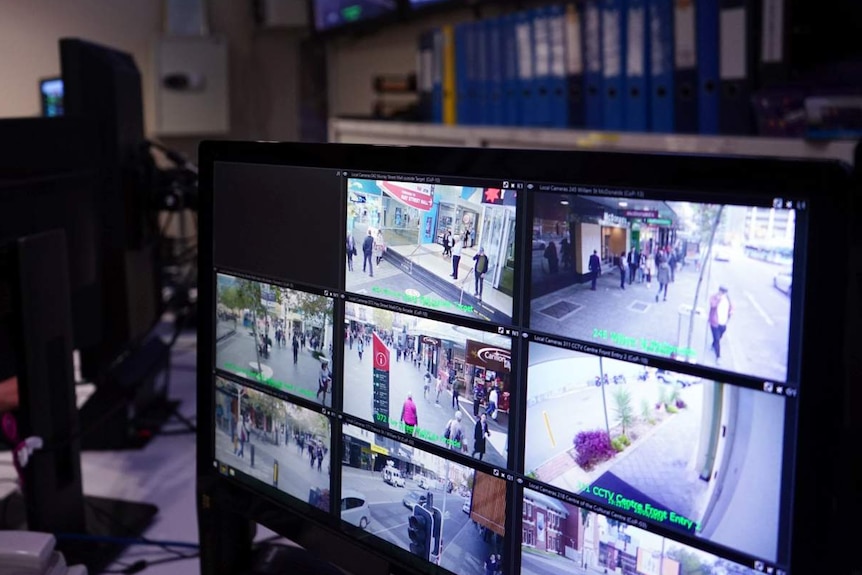 An auxiliary police officer monitors CCTV cameras at the CityWatch surveillance centre.