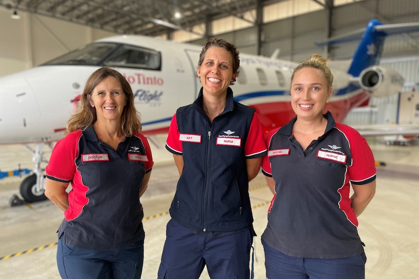 three RFDS employees smile at the camera 