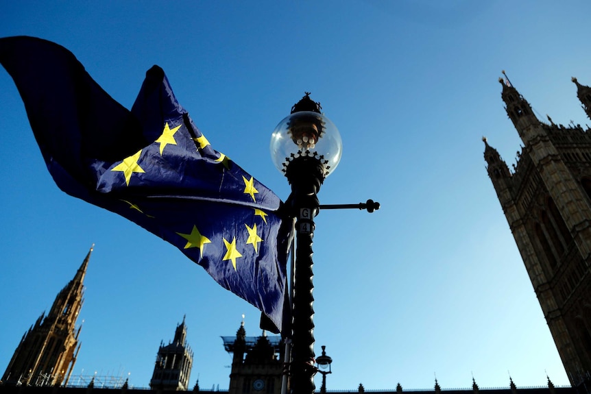 A European flag flies opposite the Houses of Parliament.