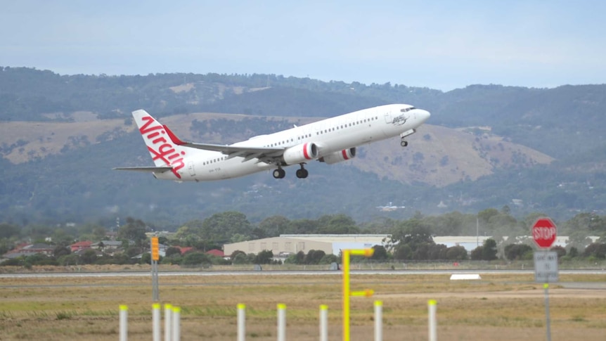 Teen tests positive to COVID-19 in Adelaide after Virgin Australia flight