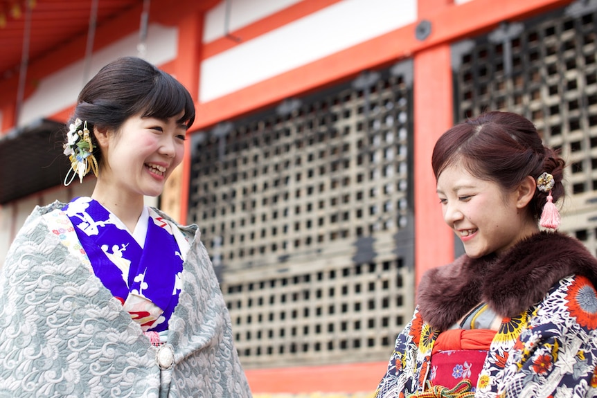 Two Japanese women in tradition dress in conversation
