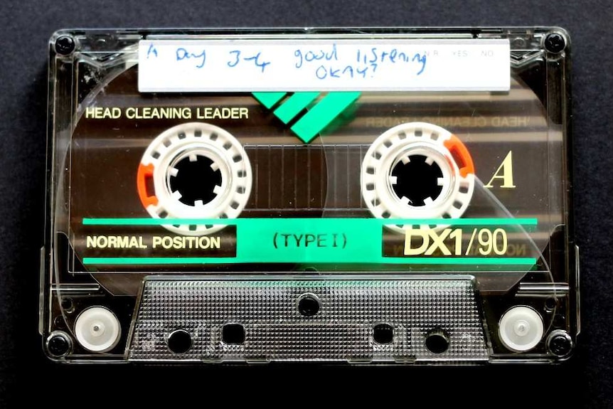An image of a cassette tape recorded by Justin Heazlewood as a child, titled 'Good listening okay?'.