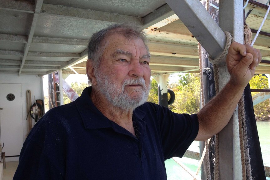 Commercial barramundi fisherman Gary Ward on his fishing boat.