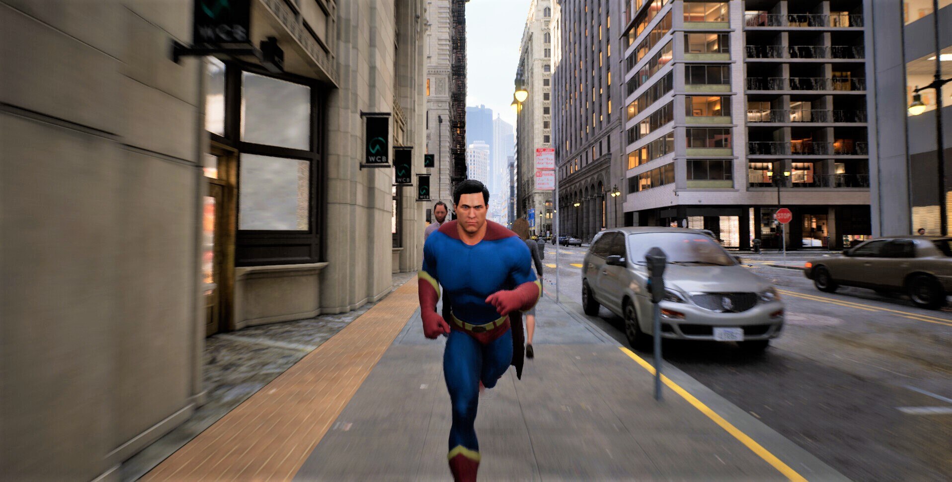 A caped superhero runs along a city street in a video game towards the camera