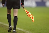 Photo of an unidentified soccer linesman and his flag.