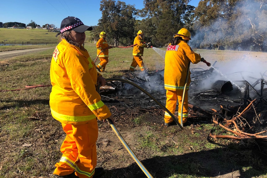 The fire brigade working in smoke near a fire truck.