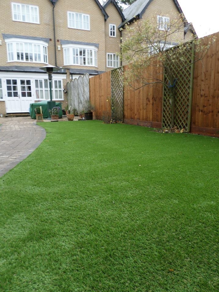 A backyard with synthetic grass.