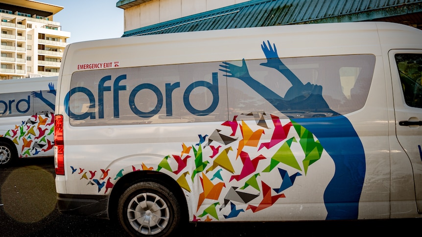 Vans with Afford branding parked outside a building