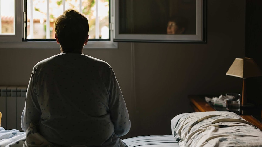 Person sitting on bed