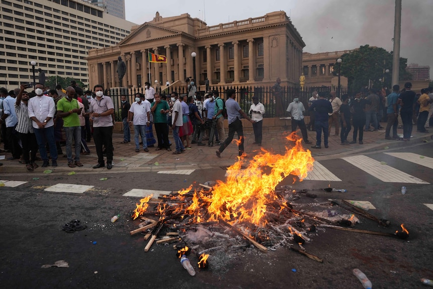 Protesters burn placards outside government offices in Sri Lanka