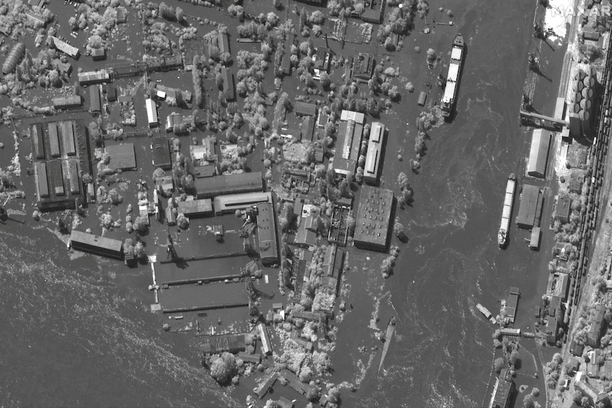 A black and white image shows the same area inundated with water. 