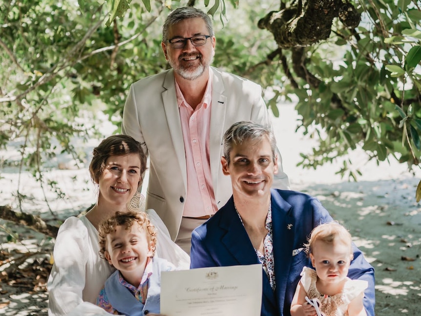 man, woman and their kids and celebrant