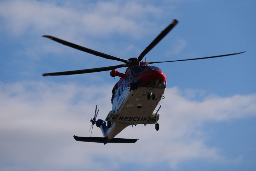 A helicopter carrying patients injured in the crash lands at Townsville University Hospital.