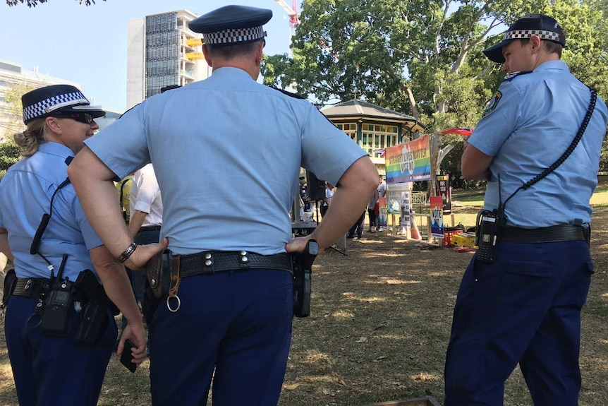 Police officers seen from behind.