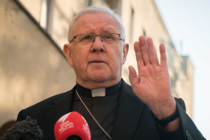 Archbishop of Brisbane Mark Coleridge gestures with his hand while taking questions about abuse in the Catholic church