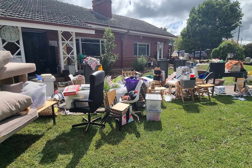 furtniture strewn on a front lawn