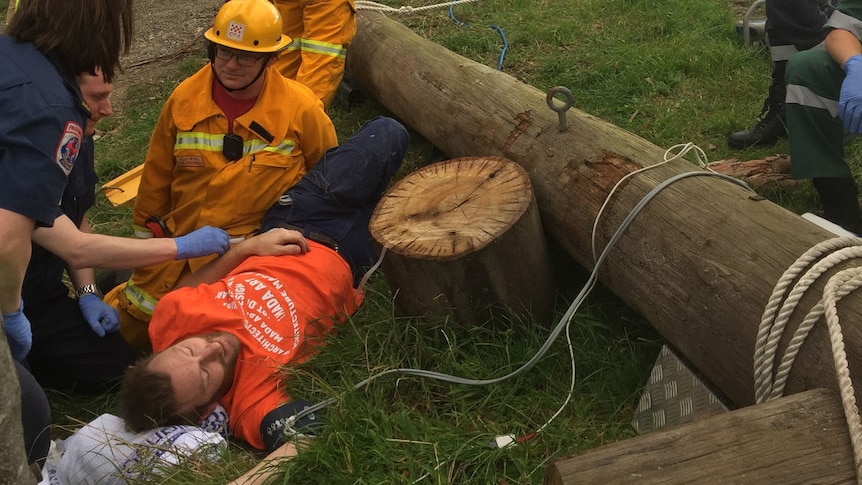 More than 20 rescuers work to free Odie Barwick who became trapped under an old telegraph pole.