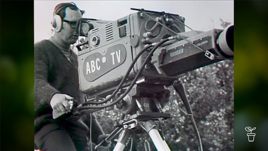 Black and white photograph of man operating old ABC TV film camera
