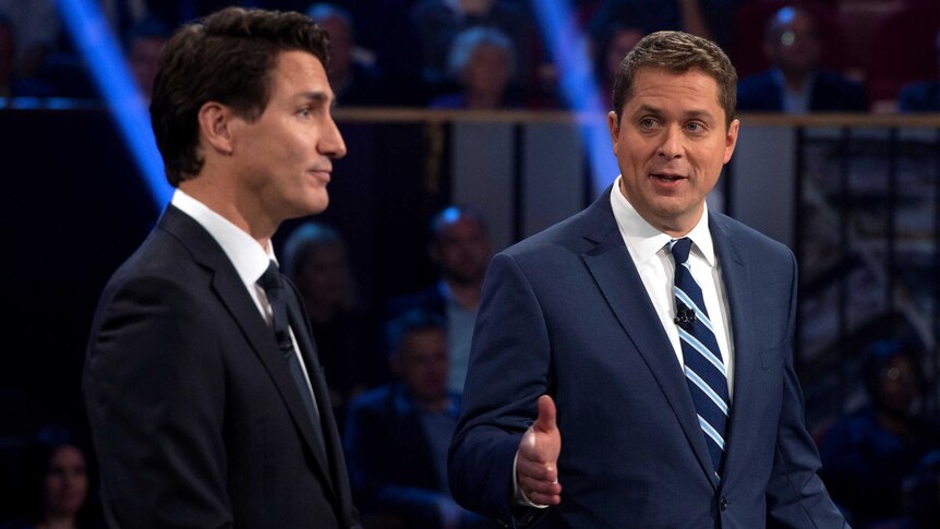 Canadian Opposition Leader Andrew Scheer talking next to Prime Minister Justin Trudeau