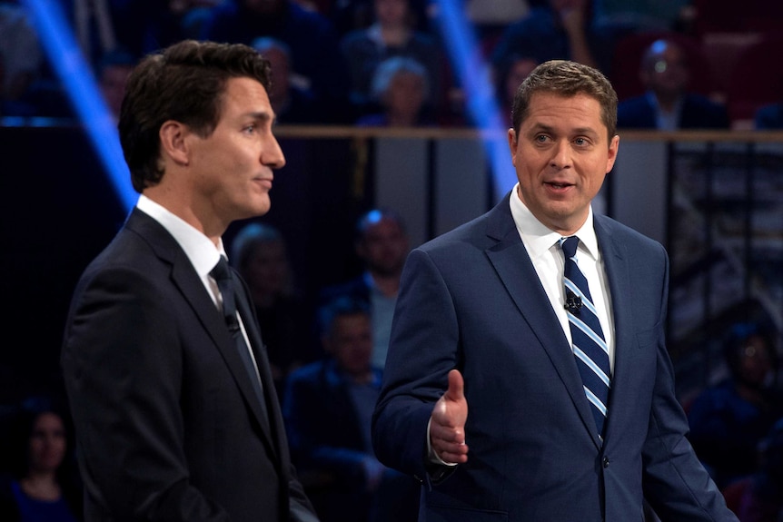 Canadian Opposition Leader Andrew Scheer talking next to Prime Minister Justin Trudeau