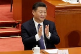 President Xi Jinping applauds after the parliament passed a constitutional amendment lifting presidential term limit.