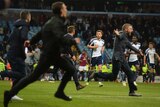 Aston Villa fans invade the pitch as West Brom players look on after the FA Cup quarter-final.