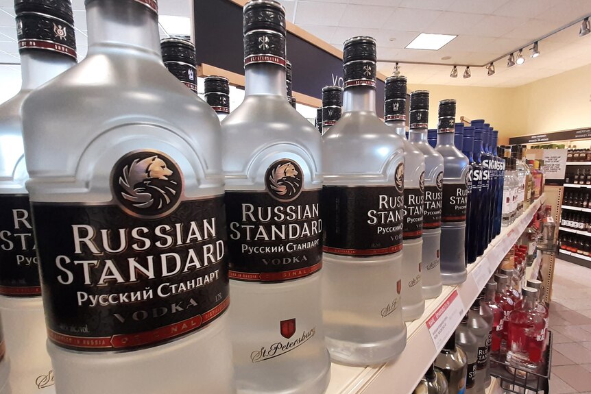 Bottles of Russian Standard Vodka lined up on a store shelf.