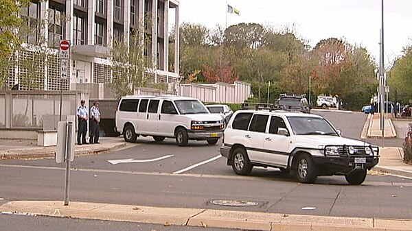 A convoy leaves the ACT City Watchhouse carrying accused murderer Russell Field
